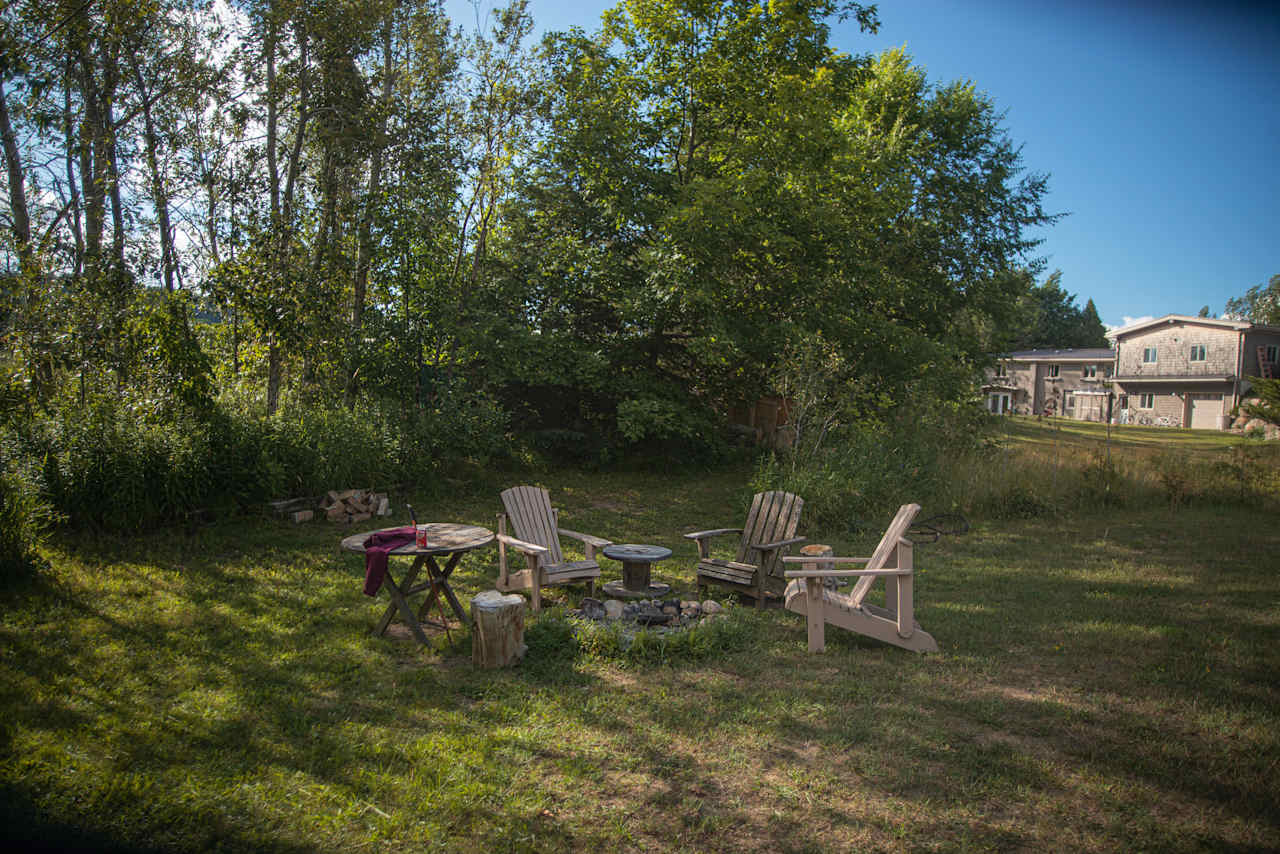 Fire pit area with view of house in the distance.