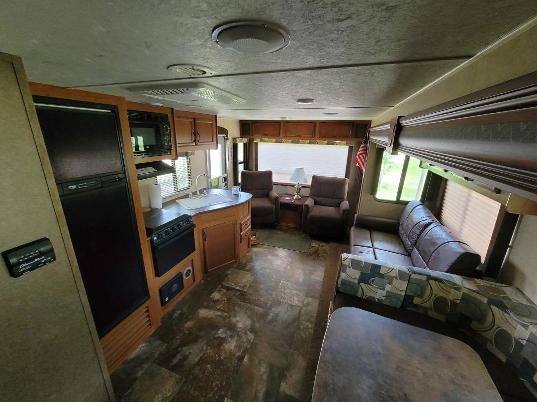 Beautiful living room with TV and full kichen.