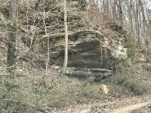 This cliff face borders the entrance road easement at the rear of outpost.