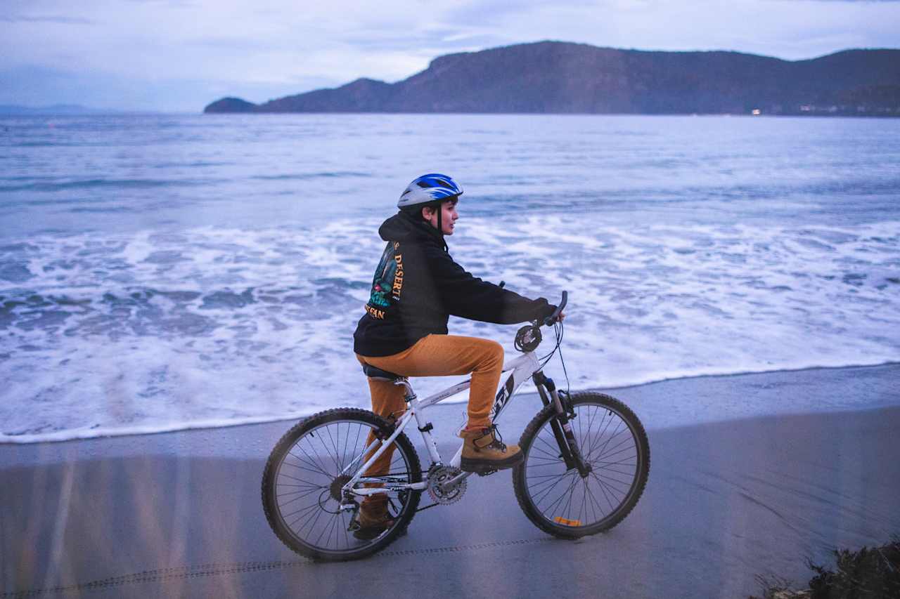 Riding the bike on the beach at sunset