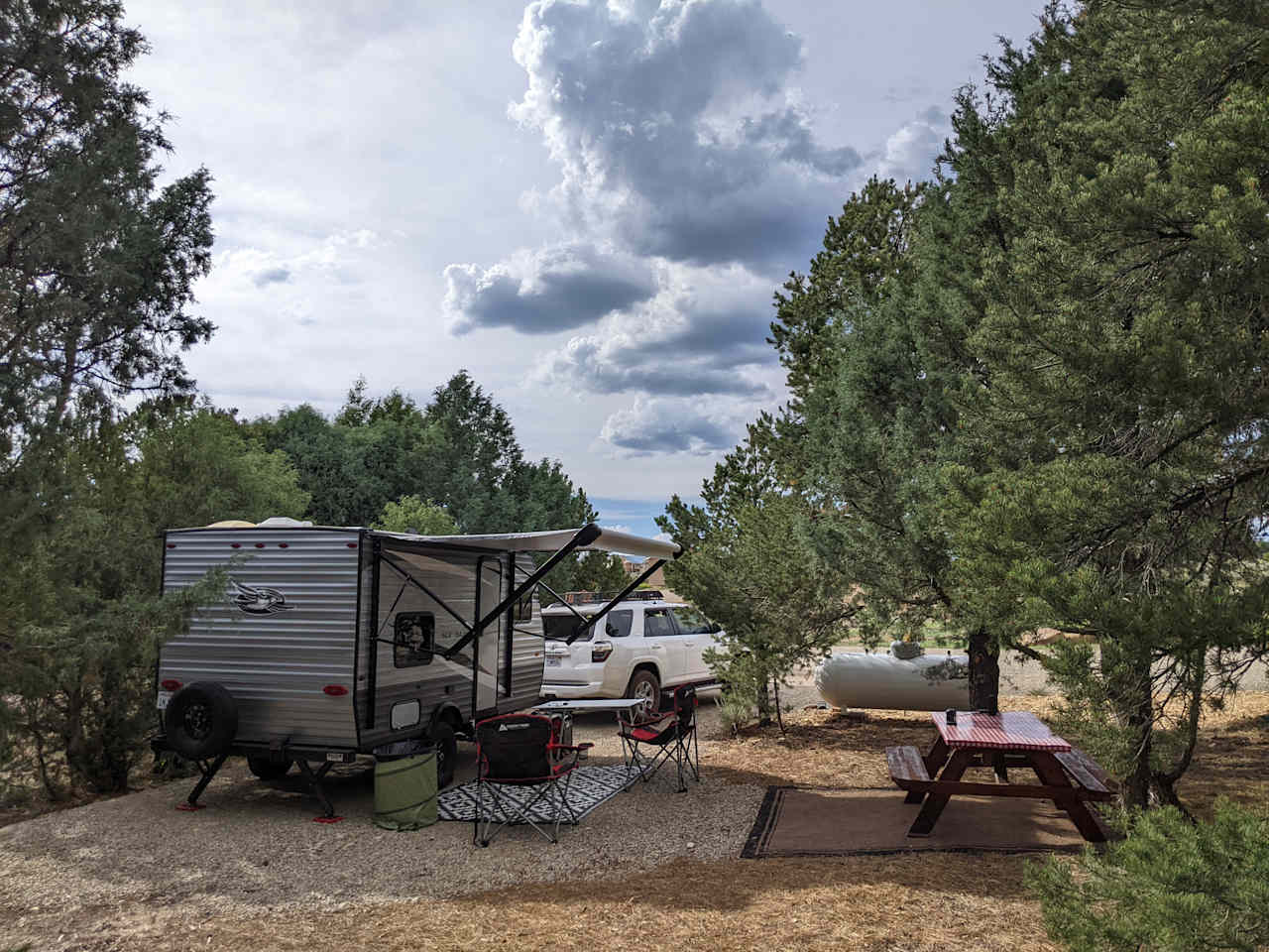 Full hookup spot with table surrounded by short trees. Within partial view of owners front porch. You can see it partially thru the trees from where our trailer was facing. No one was home when we stayed here so it worked out for us. Very clean and well cared for spot. Owner is very friendly and helpful!