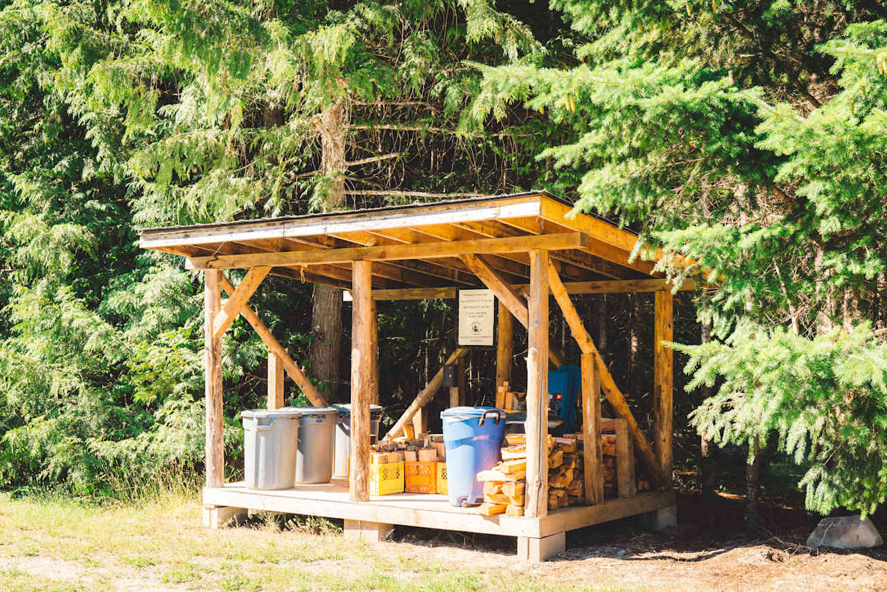 Garbage disposal shed with firewood, and pop-up tents available for extra fee.