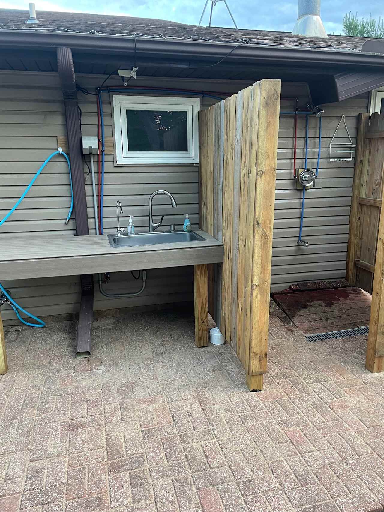 Outdoor shower and water station on the north side of Manor house.