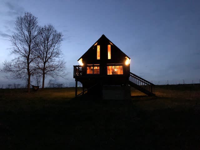 The cabin overlooks the hillside you walk up while entering.