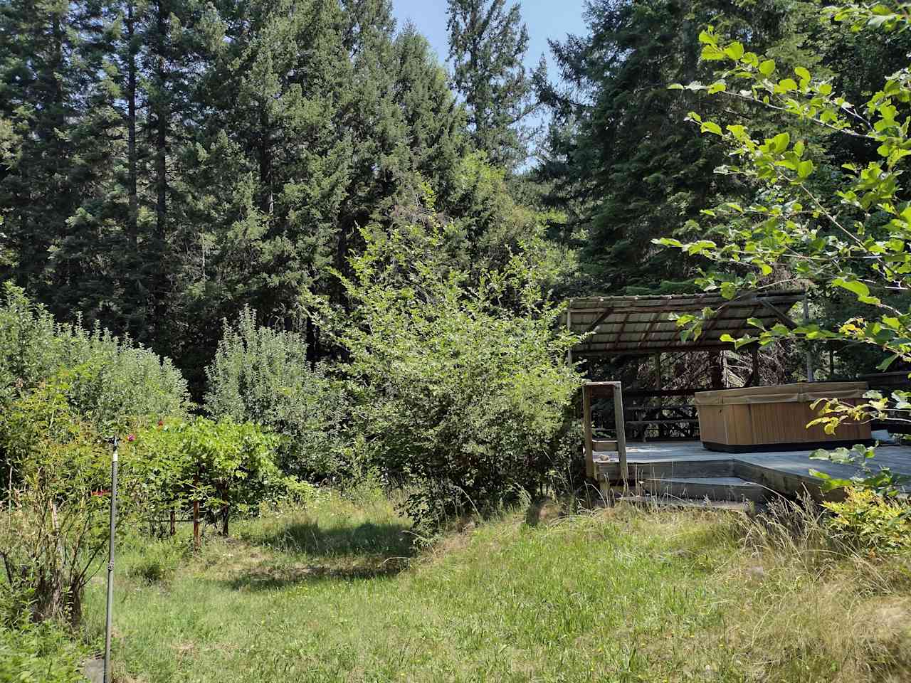 Private clothing-optional hot tub in our beautiful garden on the creek.