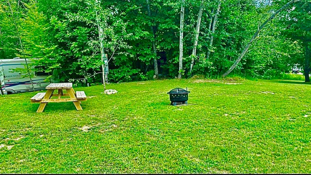 Campsite #1 Picknic table and Fire ring with attached adjustable grill grate for BBQ. ;)
