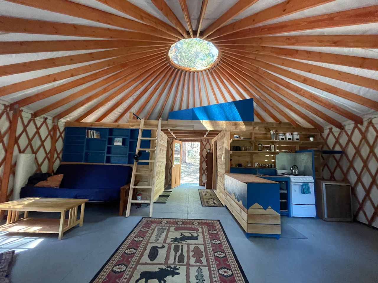 Very spacious 24' yurt with a full (dry) kitchen, battery powered lights, and a futon for a couple extra guests.