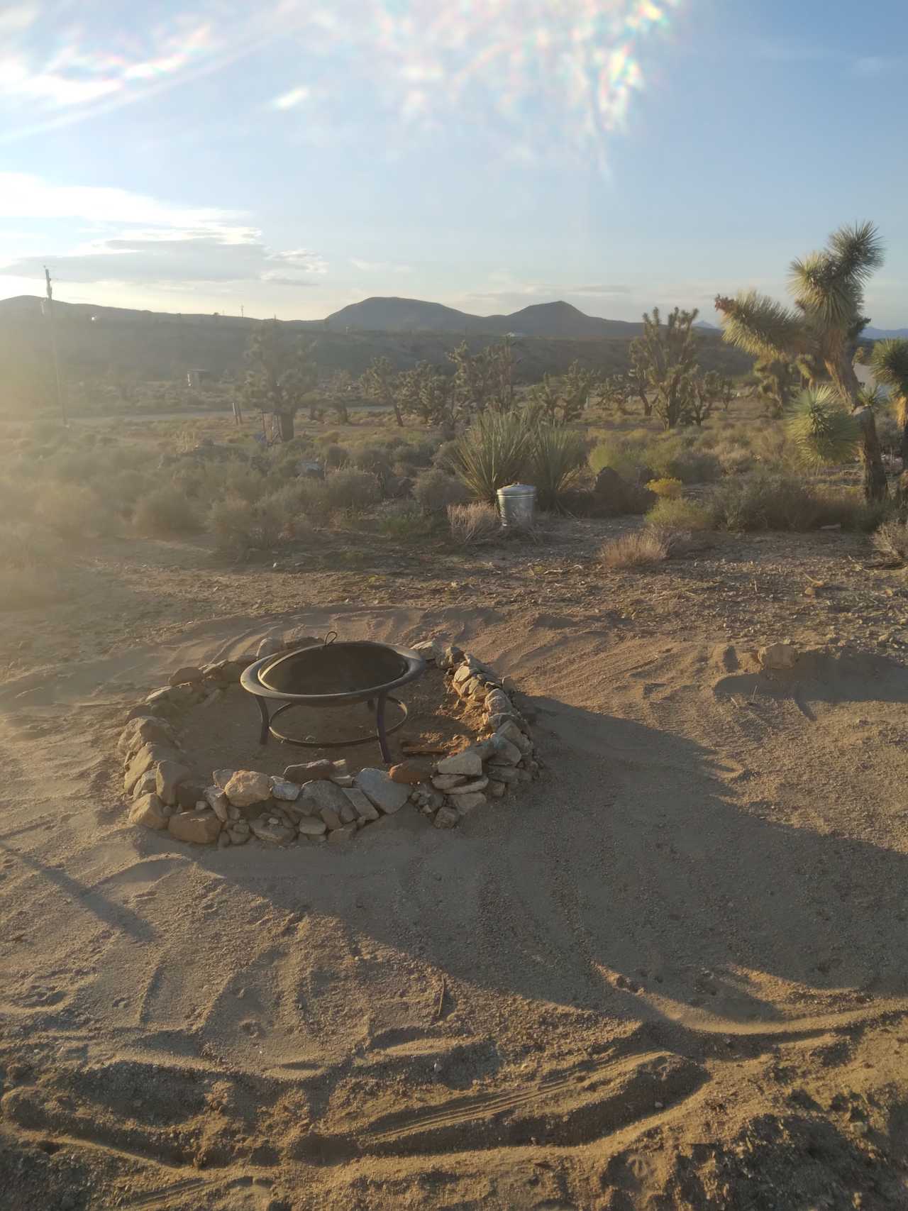 Camp fire area, with ash can. Ashes must be deposited in after done please.