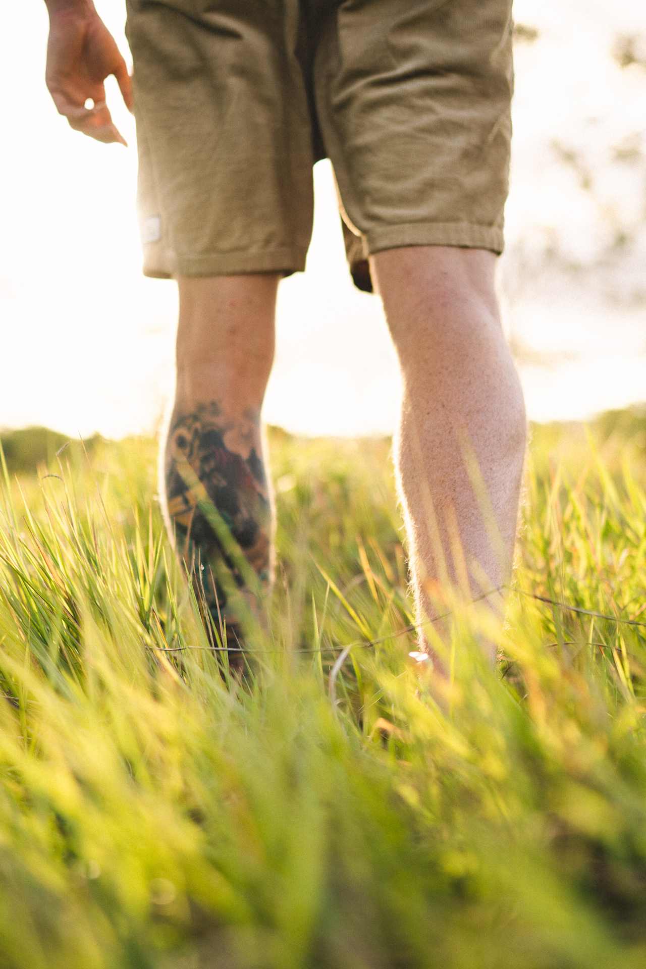 Walking through the long grass down to the dam.