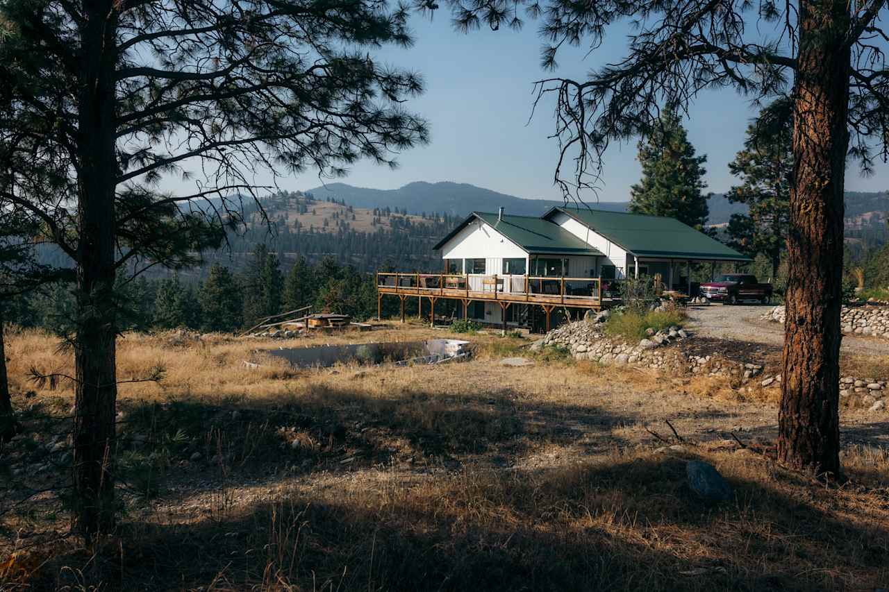 The owner's house can be seen with beautiful mountains in the background