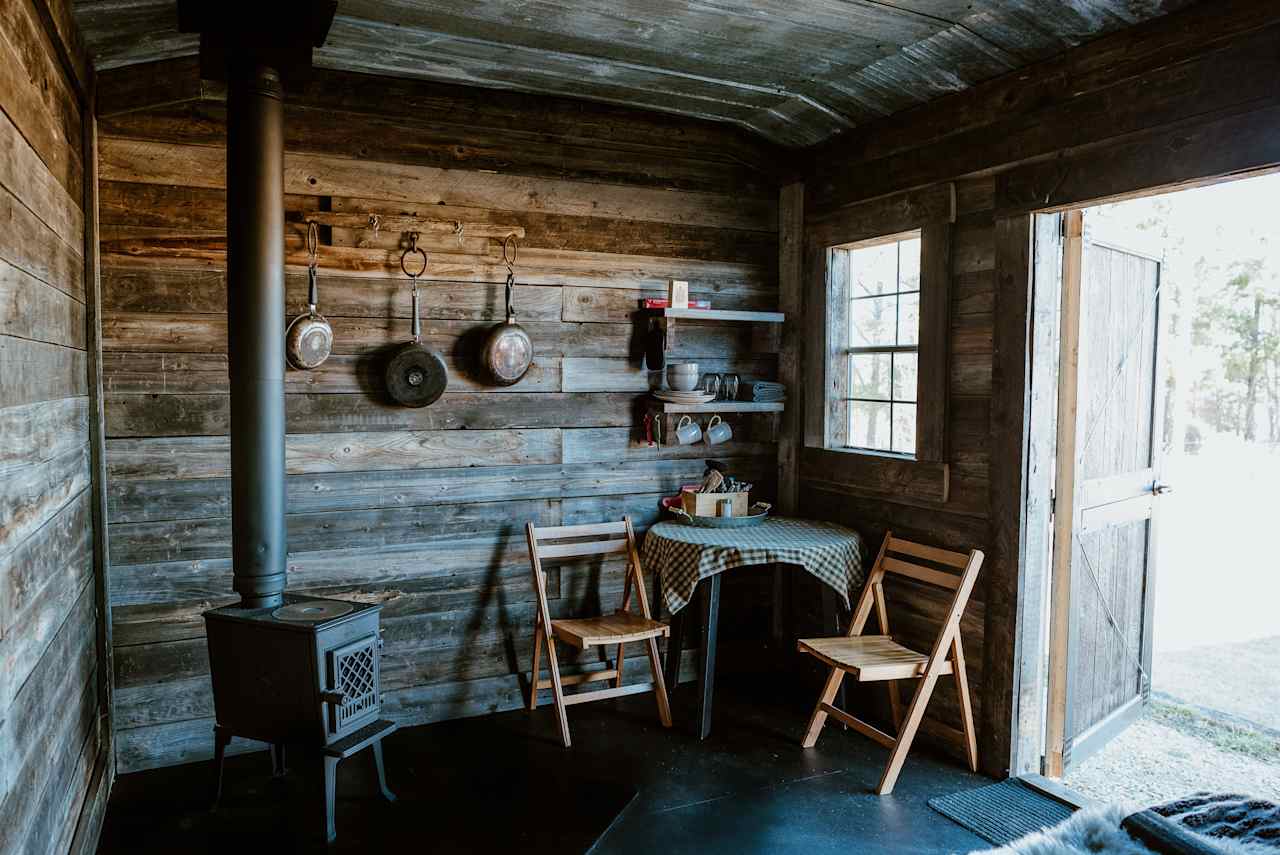 Quaint cook area, equipped with basic essentials, wood stove has a cook top and complimentary warm beverages.