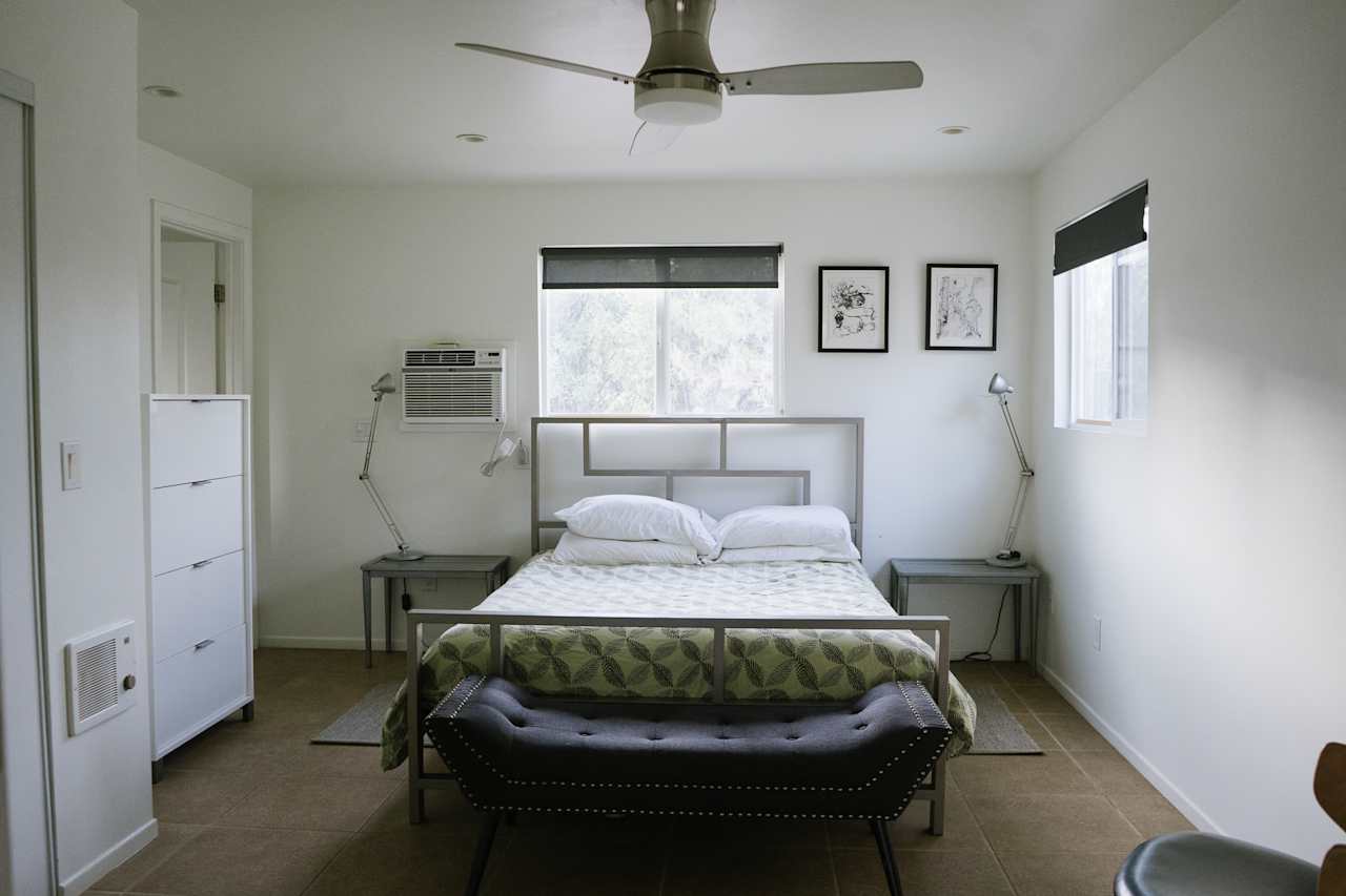 Bedroom with queen bed and attached restroom