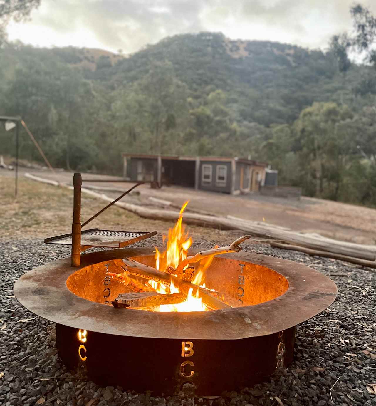 Tent site with shared facilities in the back ground. 