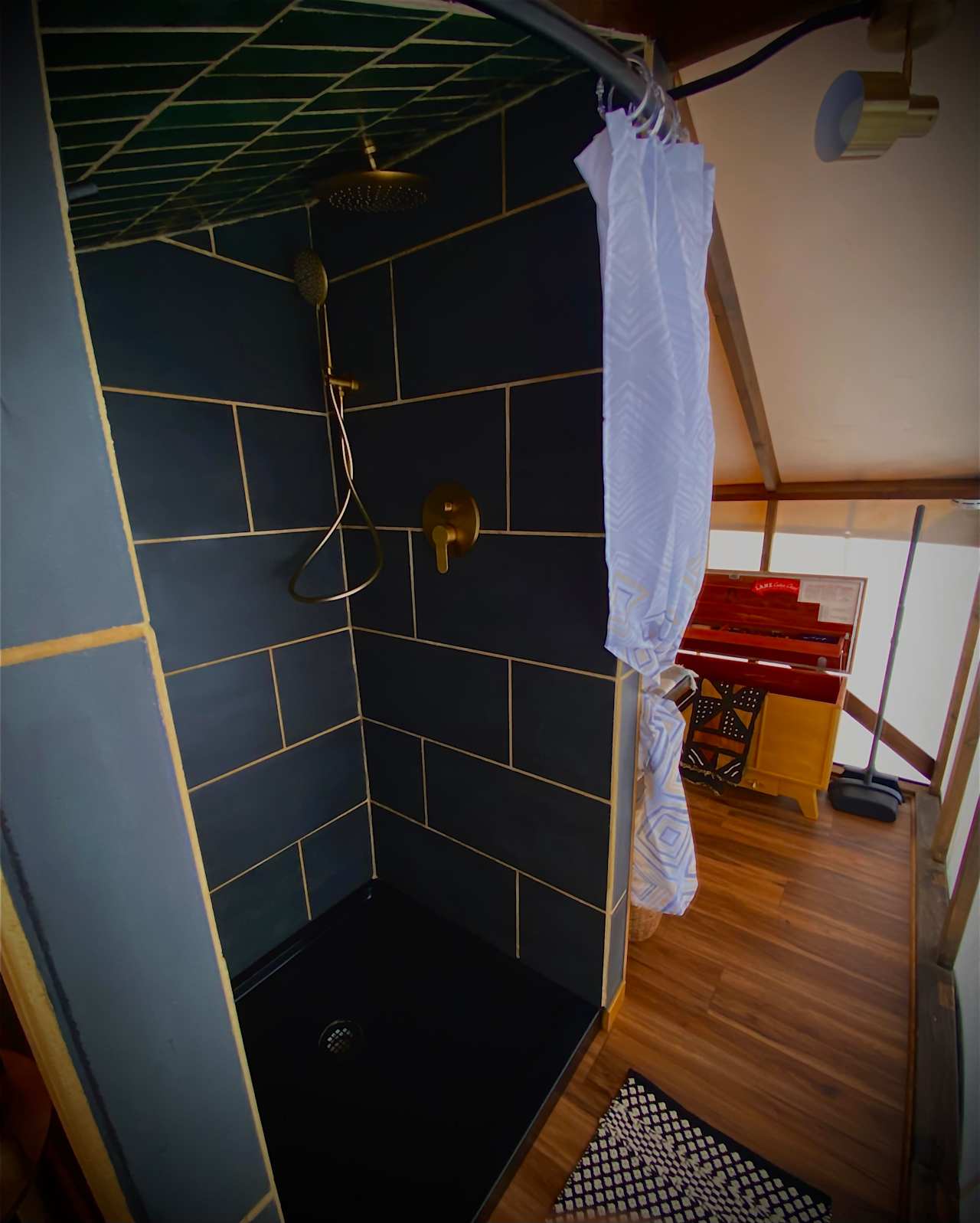 Custom tile shower with rain shower head and wand.