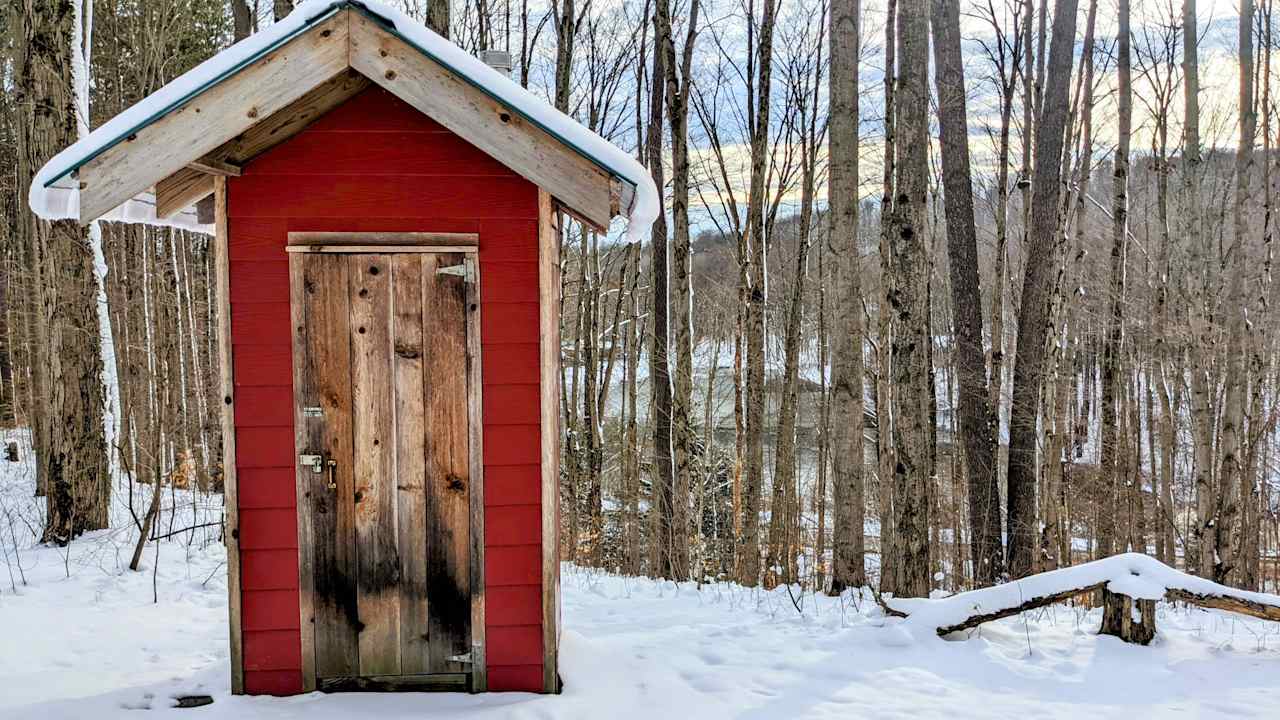 Composting outhouse with toilet battery operated lighting, toilet paper and sanitizer