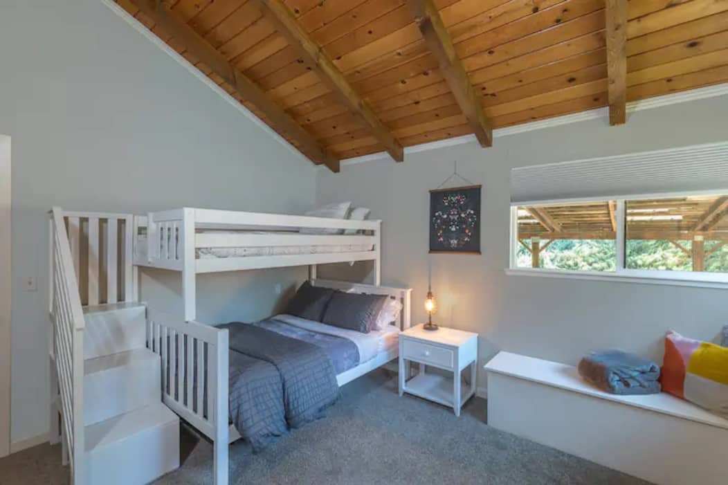 Spacious third bedroom awaits that has a bunk bed with stairs. A single bed on top and double below. Bench seating and USB enabled lamp.