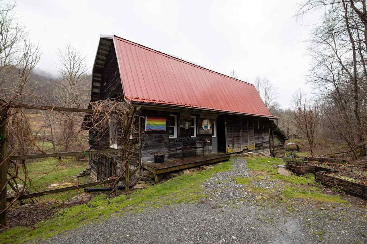 Front of the barn, with large sliding wooden door leading inside.