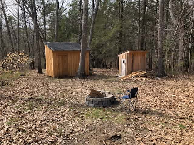 View of the cabin, sauna, and firepit