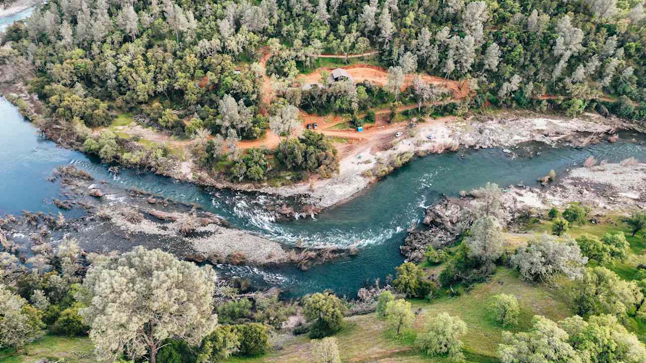 Drone view of the group site along river (house in view is recreational home and vacant)