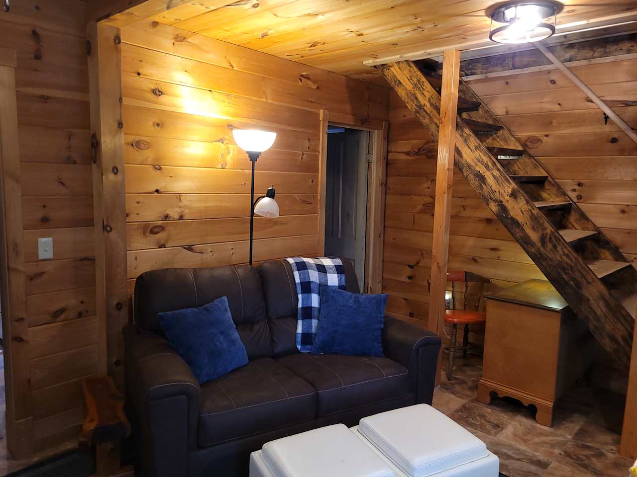 Living room with love seat, computer desk and full bath