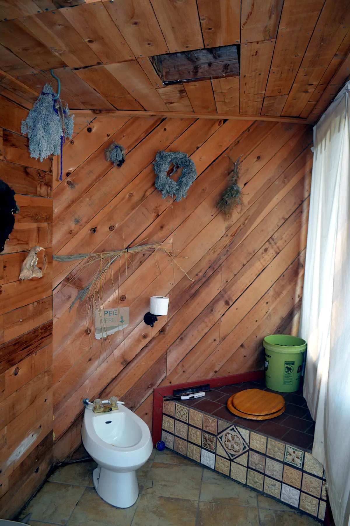 Shared bathhouse including composting toilet and bidet