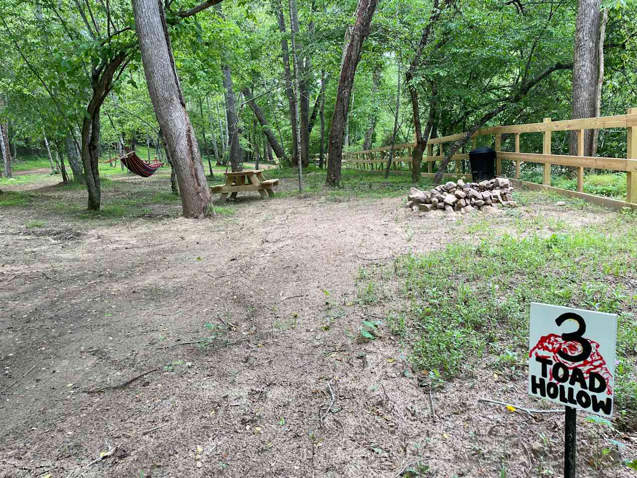 Toad Hollow is spacious, shaded, and on the riverfront with hammock, picnic table, trash receptacle and firepit. Parking is onsite