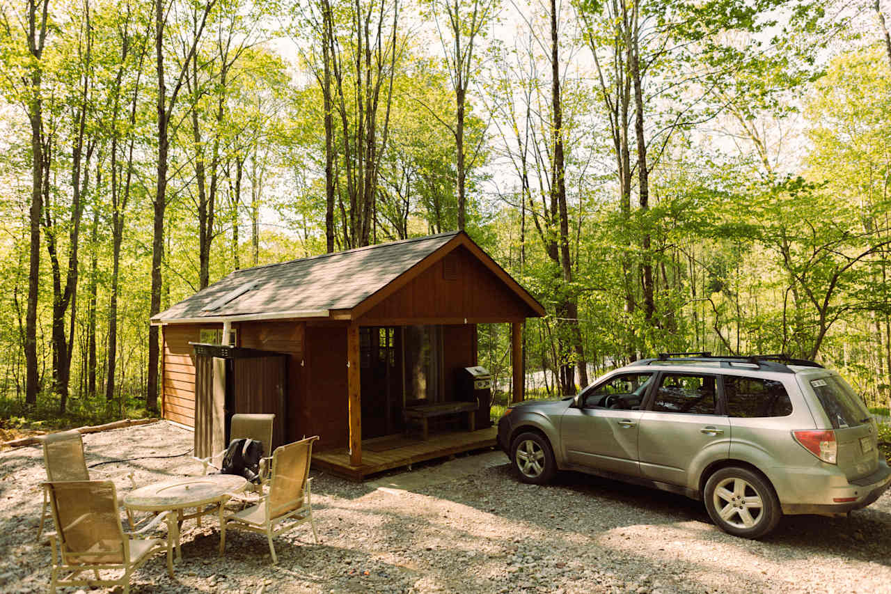 Cabin, outhouse, outdoor table, grill and porch