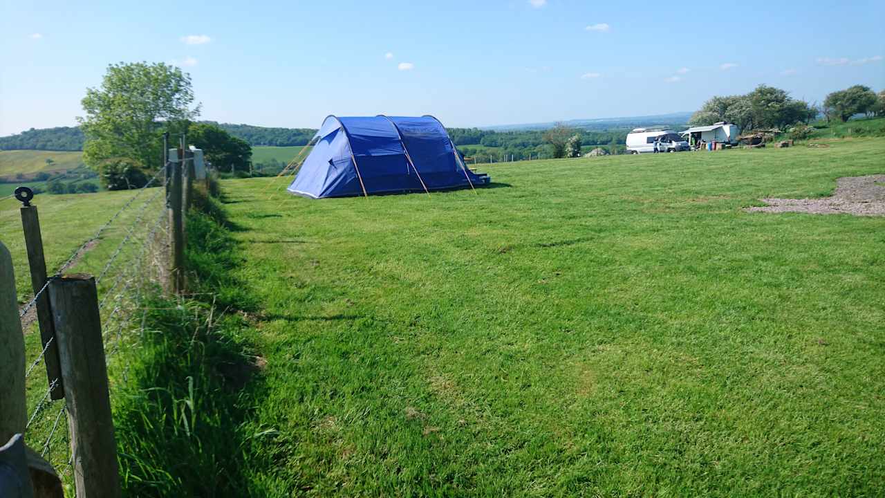 Open space camping with medium size family tent.