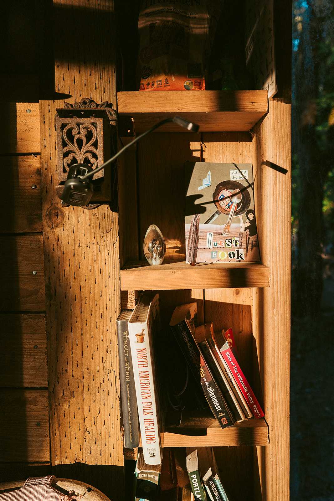 Guestbook, games, cooking equipment and books are located inside of the glass house.