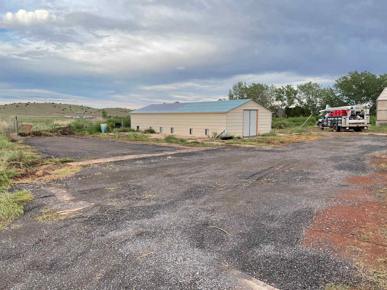 Gravel pad is behind the main house