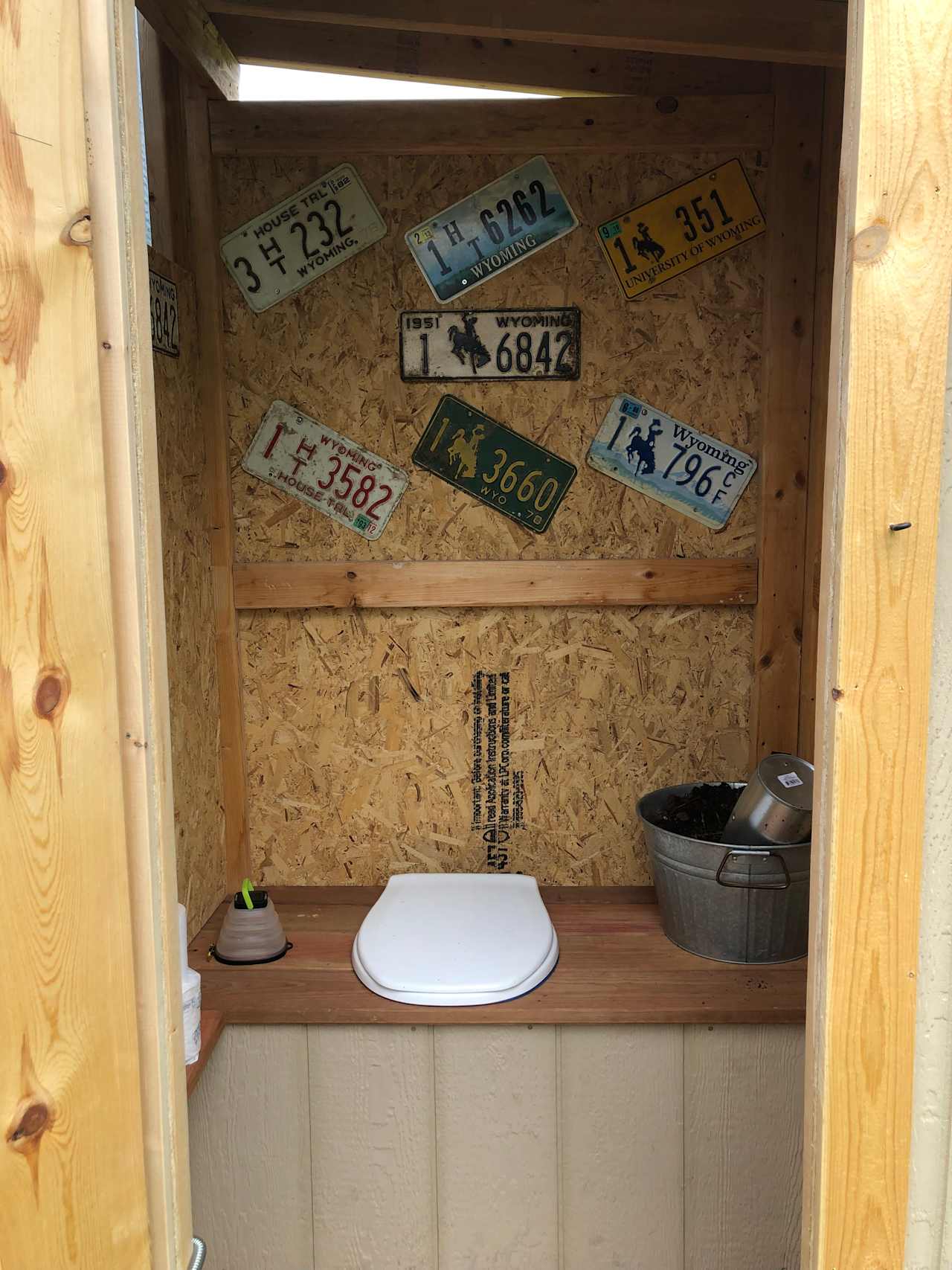 Composting toilet. Please take a seat. Add a little scoop to the bucket if you added solid waste.