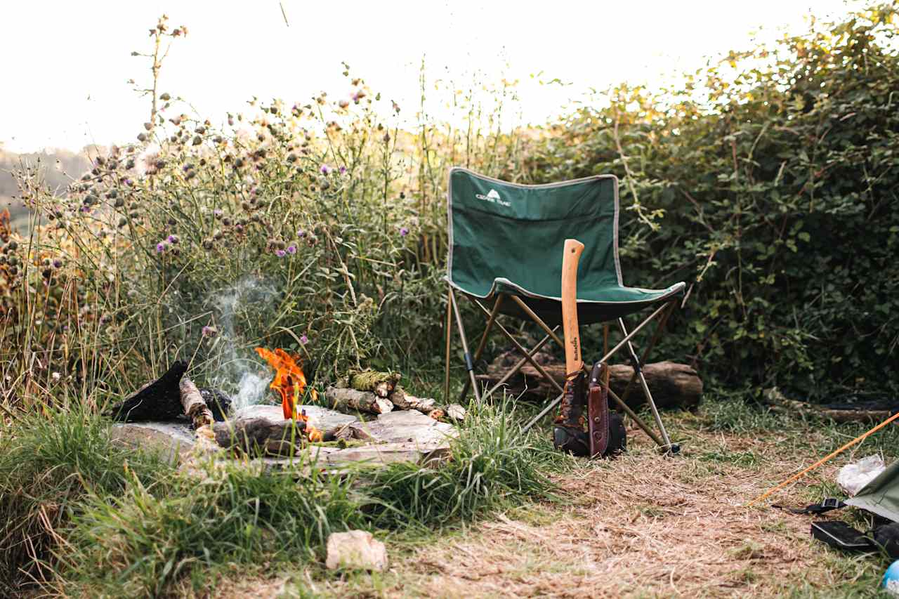 Evening campfire burning away while the sun goes down