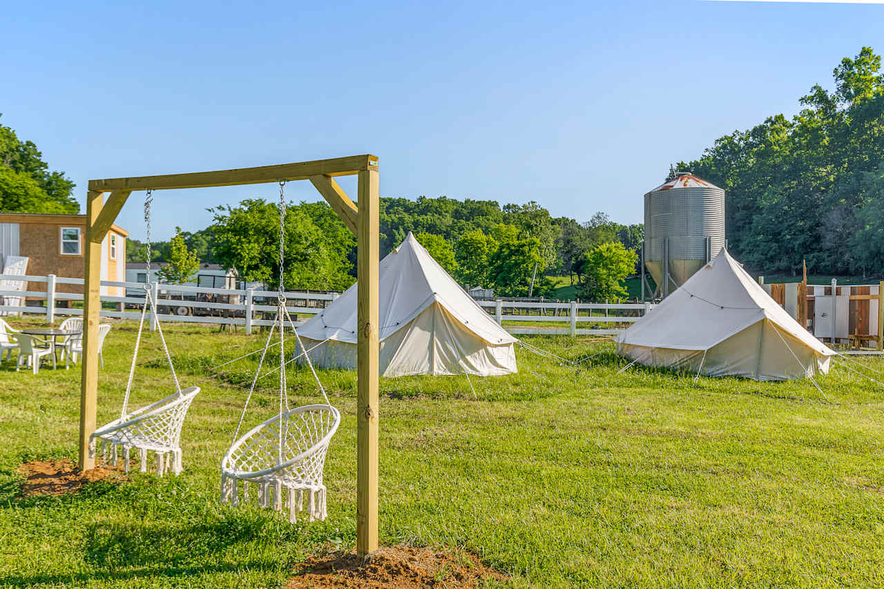 View of our two yurts with hamock in the foreground, grain bens and shower in the background