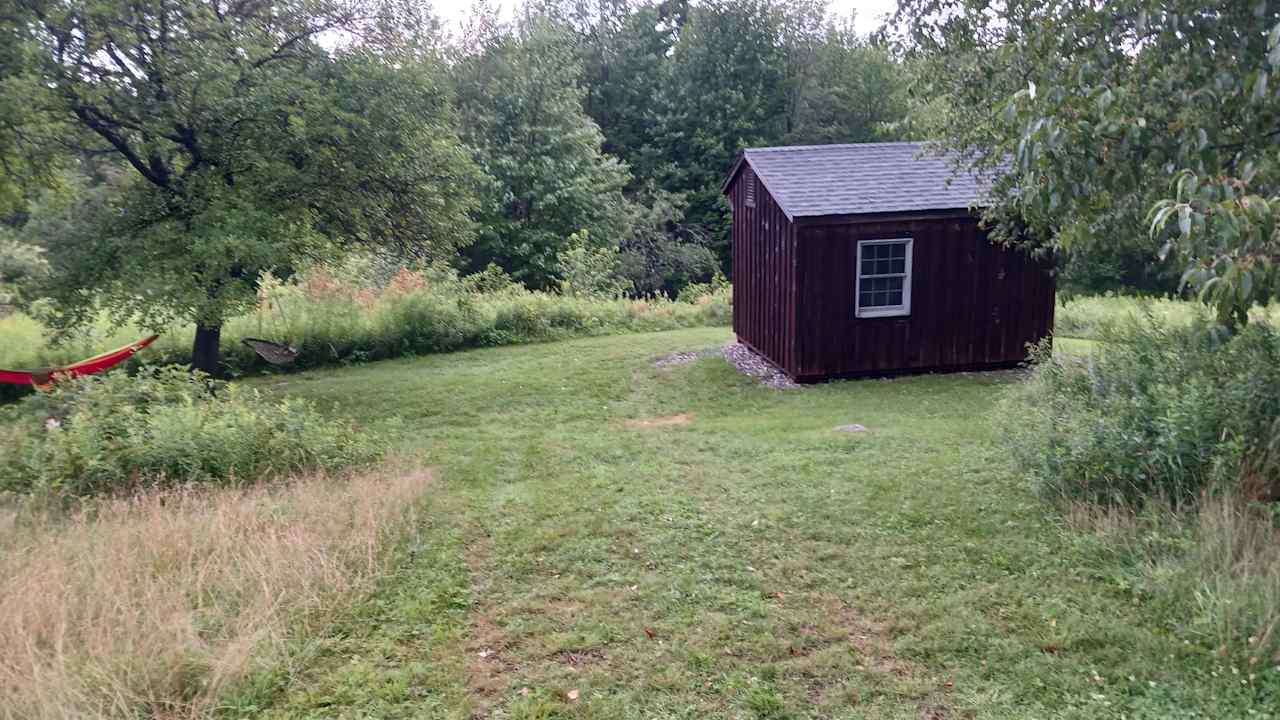 The two small trees were perfect to put our hammock. (Far left) 
Down hill is the shed in a bed and a small up hill is the campfire and picknick table.