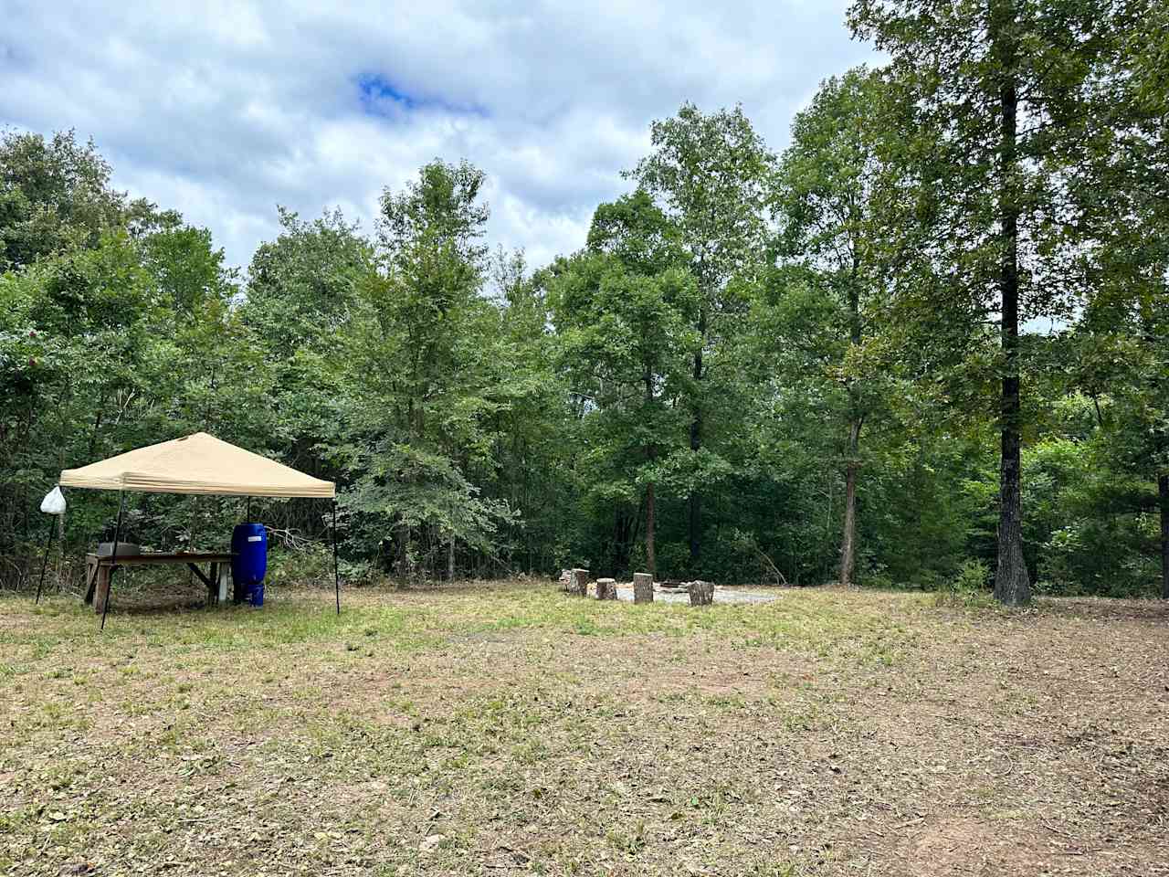 Red Gate Site - Canopy with solar lights (rental), wood counter table, 55 gallon water barrel, bin for washing, firepit, campfire grill, log seats.