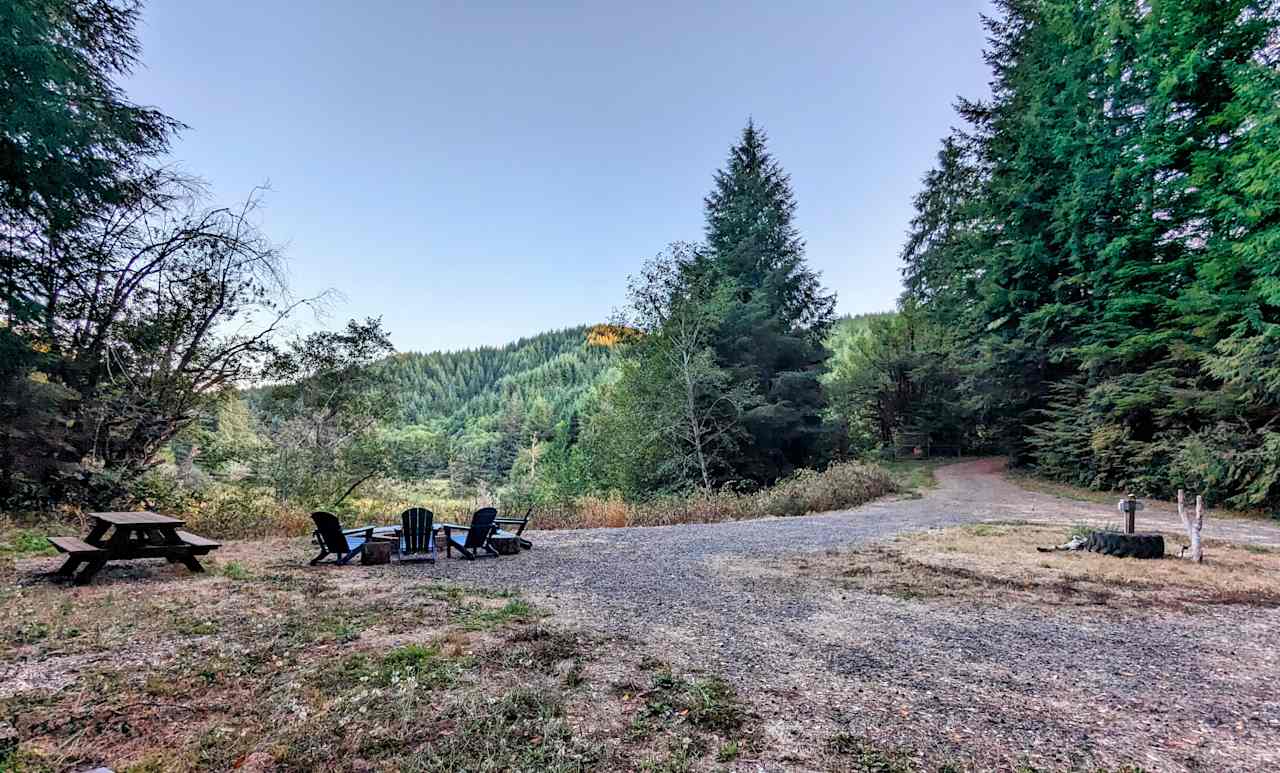 The Hipcamp site!   This leveled site is complete with electric & water access, comfortable seating around a fire pit, a picnic table and a view! 