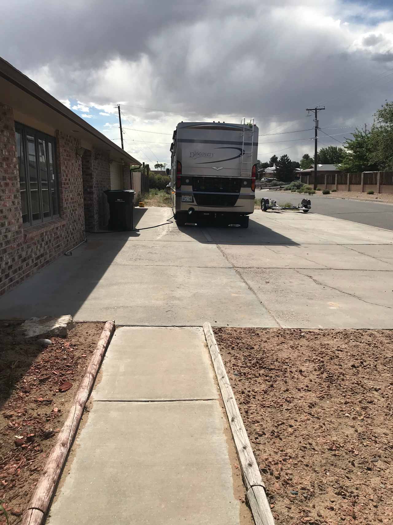 Using Google Maps, you can estimate the size of the concrete driveway.  We need two spaces, but I can park in the dirt area if needed.