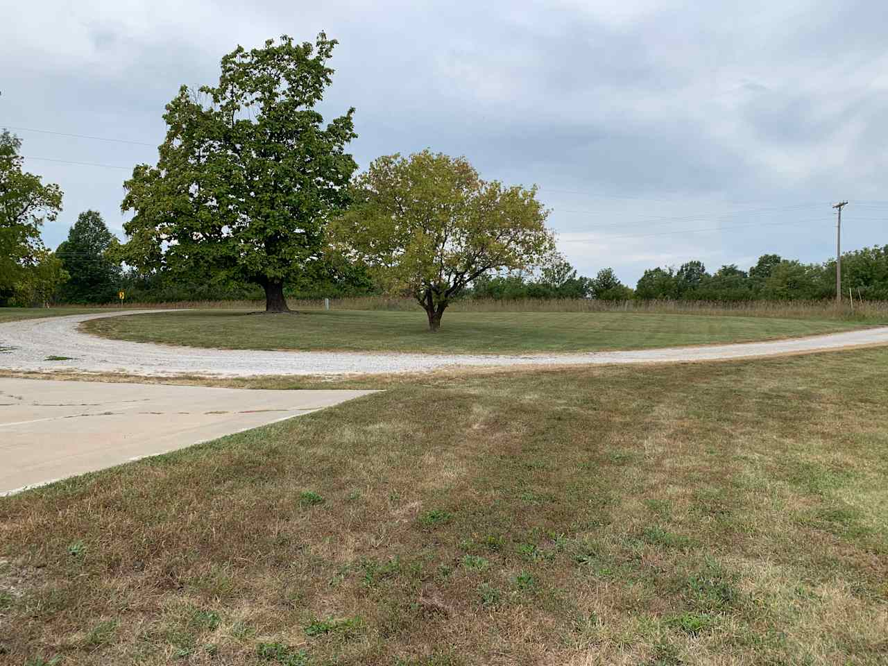 Circle drive and concrete parking area.