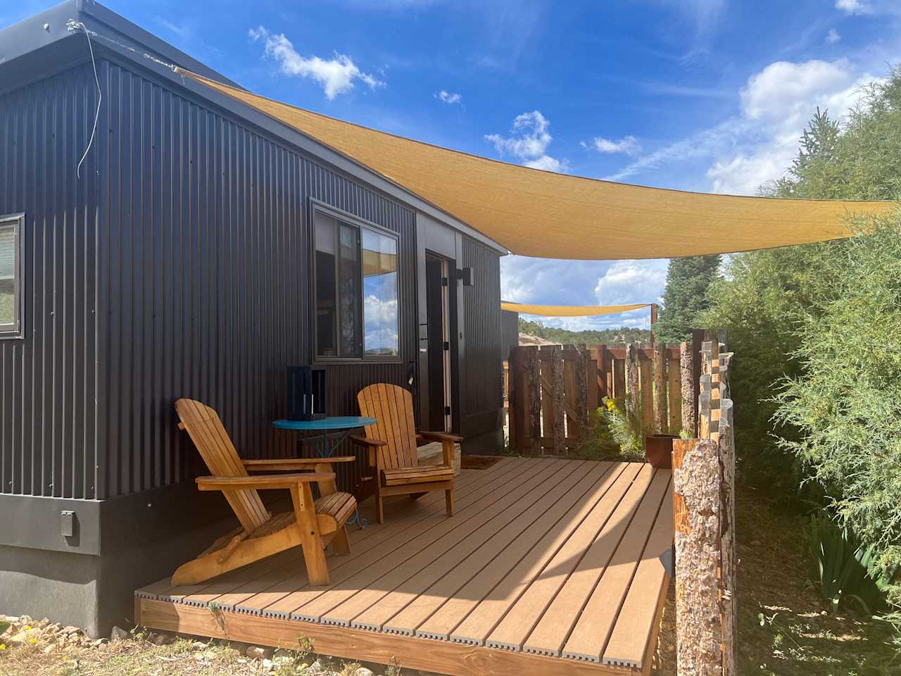 A welcoming scene on the tiny house porch, nice and private from the other sites