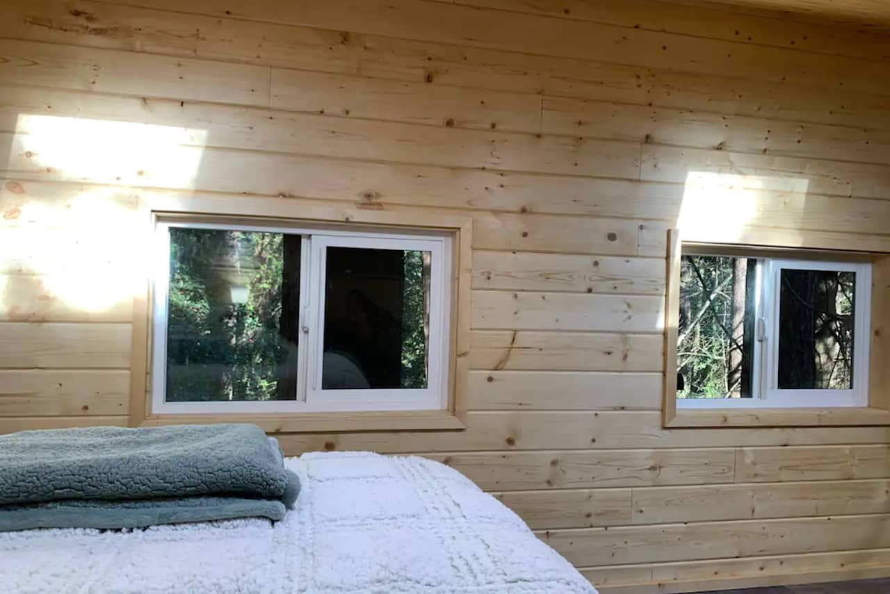 Light streaming in through skylights onto the master bed.