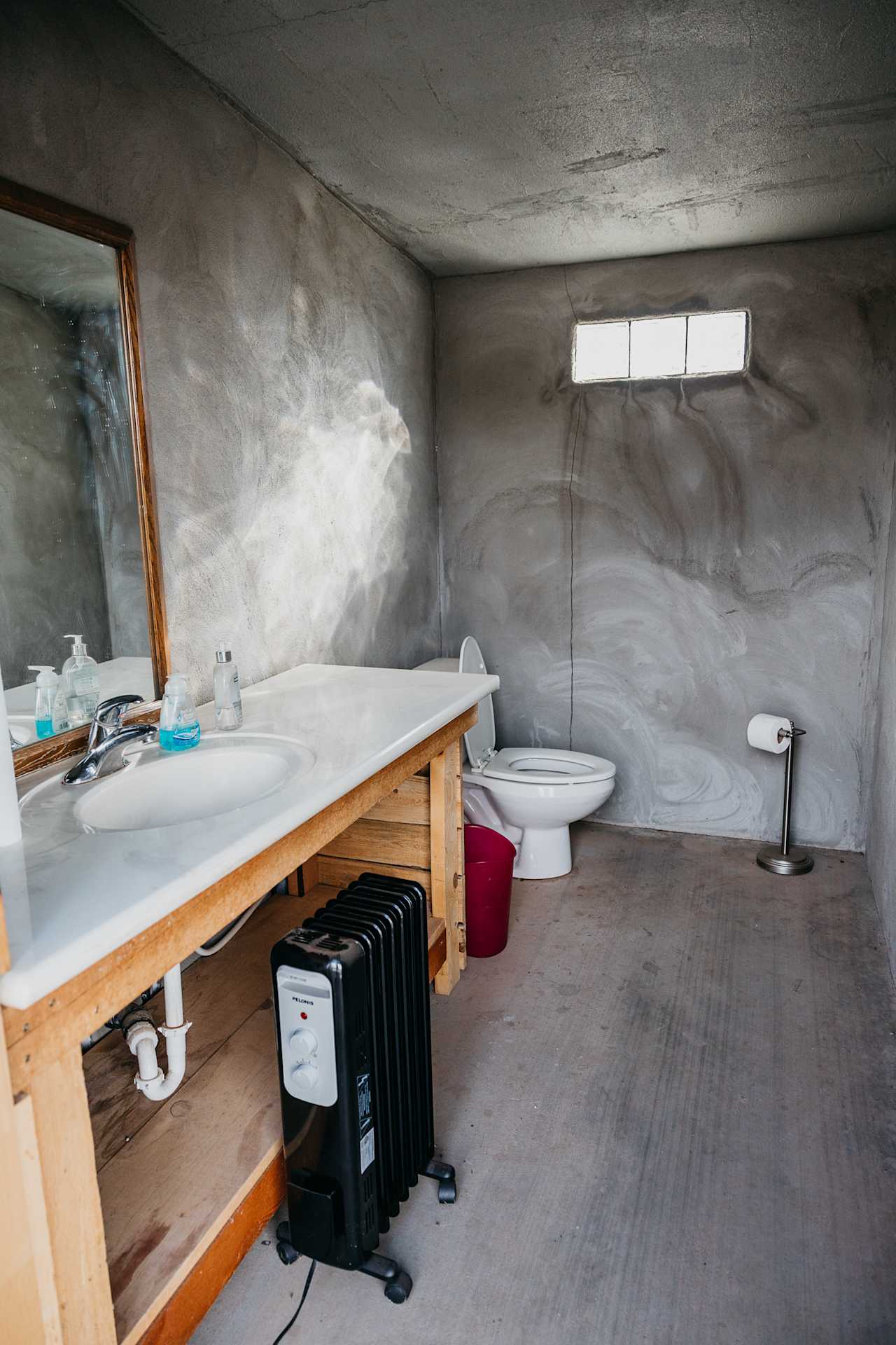 Inside the bathroom. There is a heater to keep it warm at night.