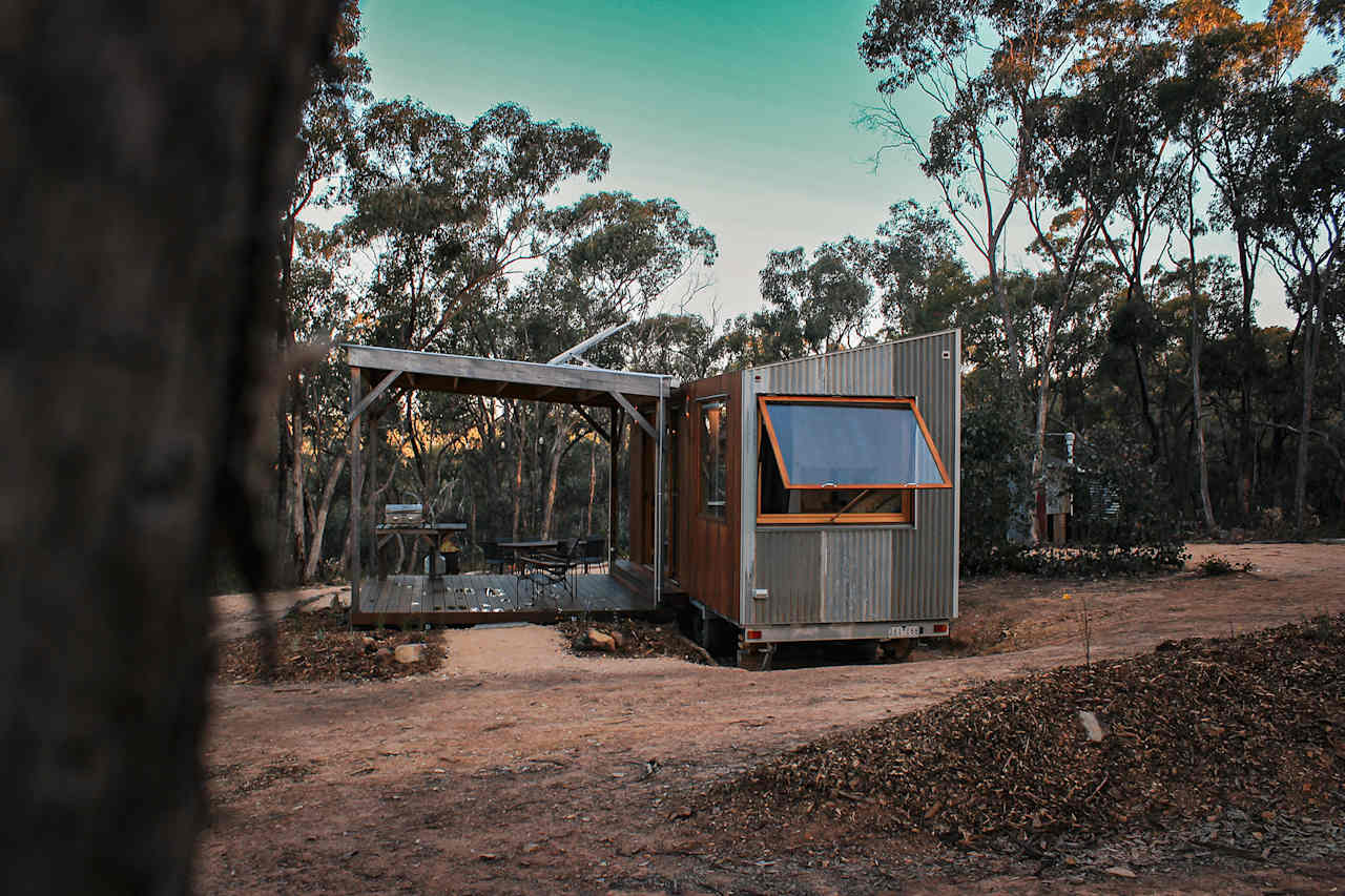 Award winning craftsmen built tiny house is at ease nestled into the landscape
