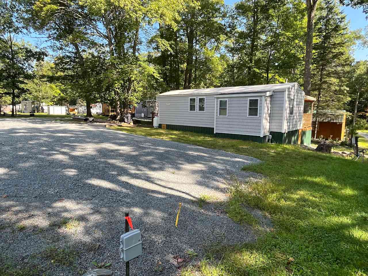 Gravel pad RV site next door to host's unit.  Has picnic table, grill and next-door fire ring.