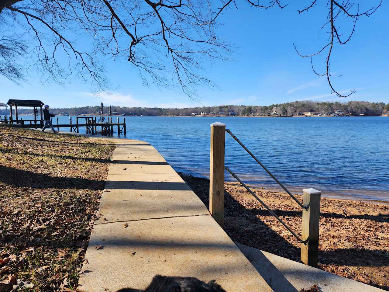 In winter. Sidewalk to left along water.  Other pier in distance. Nice sandy beach