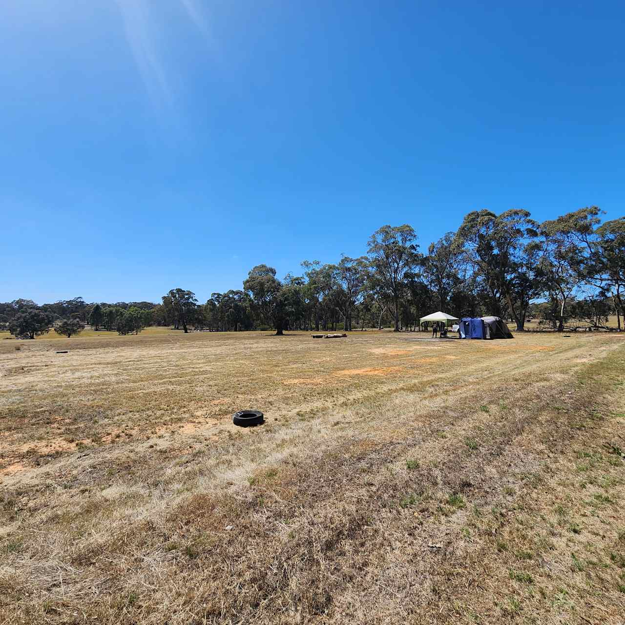 Campsite viewed from the north western corner. Fire pit area middle top and tent set up is a 3 room tent with gazebo and shower/toilet tent.