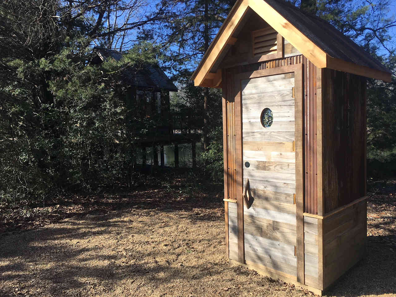 Rustic outhouse in reclaimed cedar and rusted barn tin