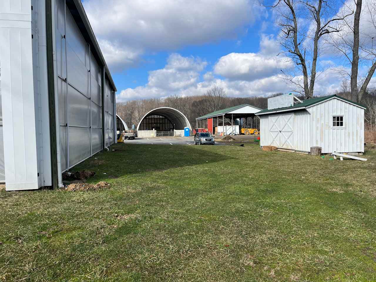 This is the view from the grass to the camp site. The building on the left is an event venue and to the right is a shed for lamb cuddling.
