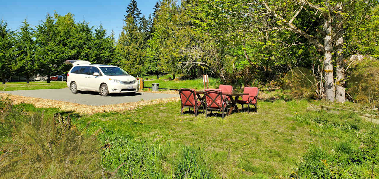 Level gravel pad, full hookups, picnic table and firepit with free firewood.