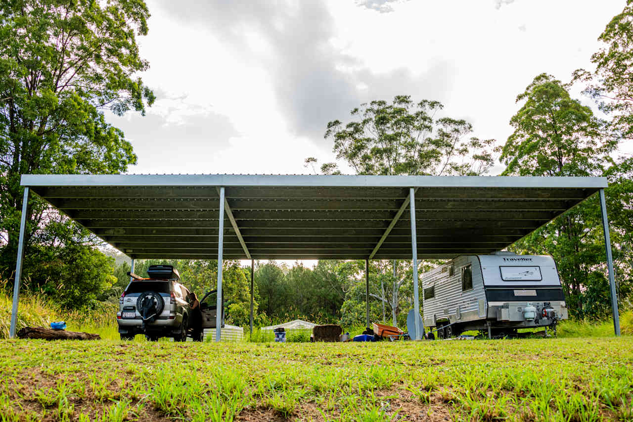 Covered Shed space provided next to occupied caravan.