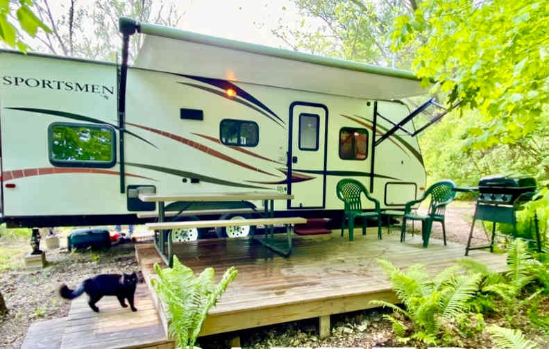 Early summer 2023 beautiful day at your camper with private deck, firepit, cave and waterfall. (Sometimes a dog or cat will visit you, so make sure your pet is always on a leash)